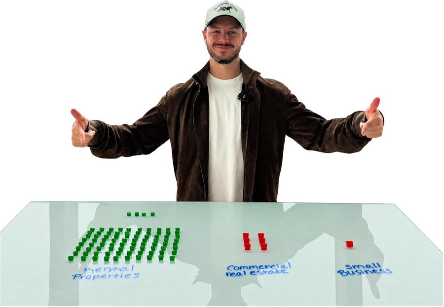 Brian Luebben behind a table showing about 80 green rental houses, a handful of red commercial properties and 1 red small business