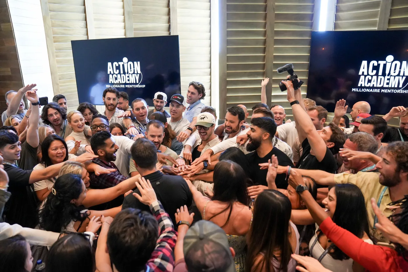 Action Academy members celebrating together at a live event